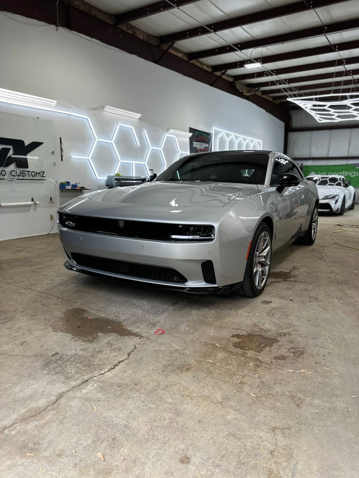 Silver Dodge Charger parked inside the Prime Auto Lab shop