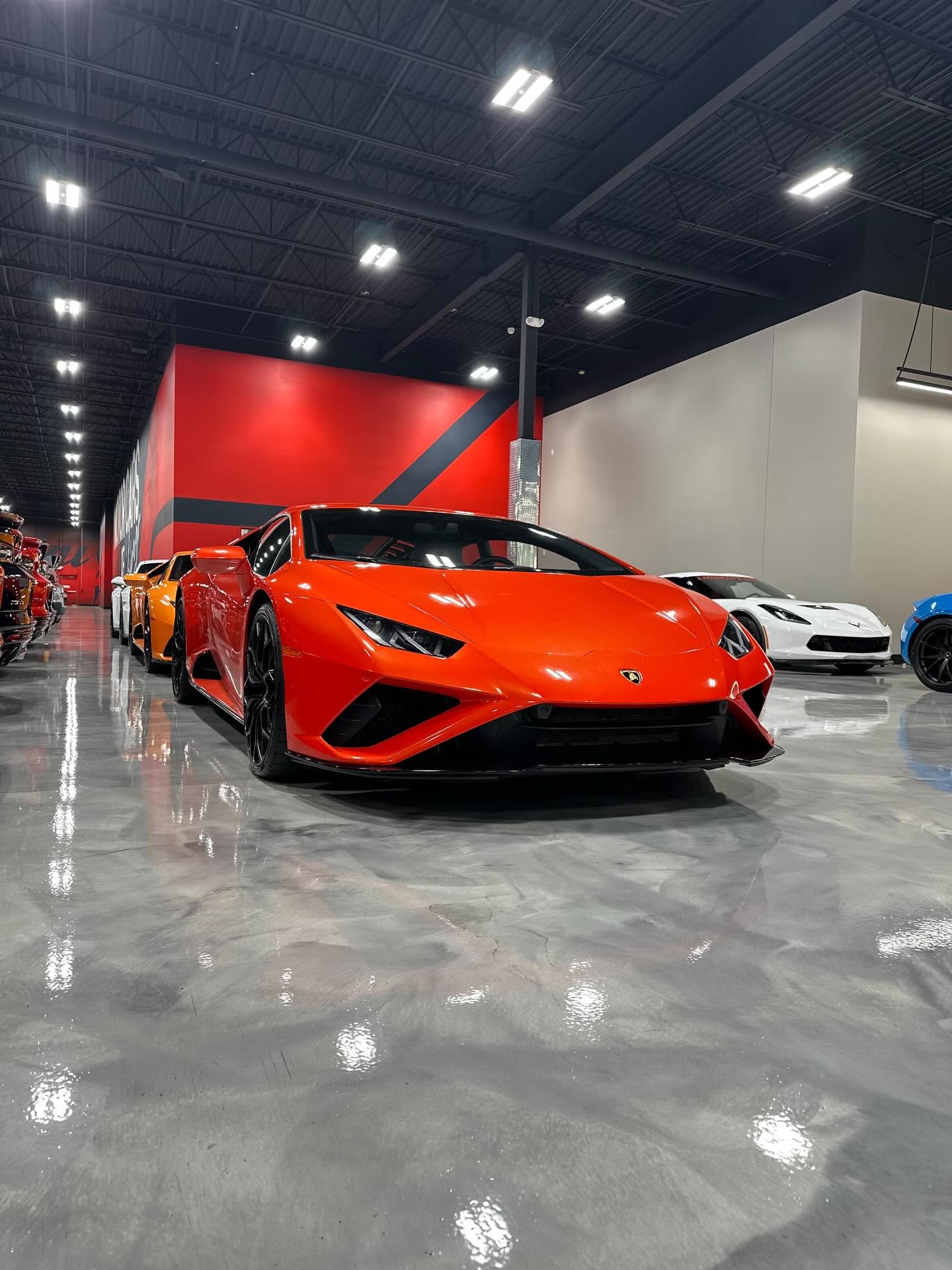 Orange Lamborghini Huracán inside the Prime Auto Lab showroom